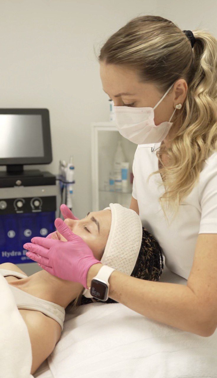 Tatiana giving a client a facial massage